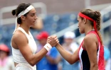 La Française Caroline Garcia (g) serre la main de la Portoricaine Monica Puig après l'avoir battue au 2e tour de l'US Open, le 30 août 2018 à New York