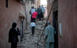 Des habitants sortent à travers les décombres de la vieille ville de Marrakech, endommagée par le tremblement de terre, le 9 septembre 2023