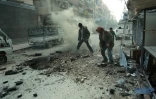 Des hommes constatent les dégâts après un bombardement du régime sur Douma, la principale ville de l'enclave rebelle dans la Ghouta orientae, le 10 mars 2018