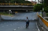 Un cycliste circule sur une route déserte de Cali (Colombie), lors du couvre-feu imposé pour tenter d'enrayer la propagation du virus, le 17 avril 2021