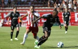 Le Lorientais Stéphane Diarra devance le milieu d'Ajaccio Vincent Marchetti, le 4 septembre 2022 à Ajaccio  