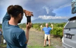 Un touriste étranger se fait photographier devant le mont Agung, le 27 novembre 2017