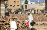 Un homme marche dans les ruines à Derna, dévastée par les inondations, le 18 septembre 2023