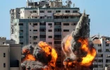 Des boules de feu jaillissent d'un bâtiment qui abritait les locaux de médias internationaux, pulvérisé par une frappe israélienne, le 15 mai 2021 à Gaza
