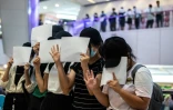 Des manifestants brandissent des feuilles blanches en signe d protestation contre la nouvelle loi sécuritaire chinoise, à Hong Kong, le 6 juillet 2020