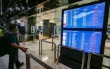 Un voyageur à l'aéroport Soekarno-Hatta de Tangerang après l'éruption du volcan Anak Krakatoa consulte le tableau des départs pour connaître le statut des vols, le 6 septembre 2026 en Indonésie