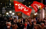 Des militants du parti social-démocrate (SPD) allemand agitent des drapeaux devant le siège de la formation, le 26 septembre 2021 à Berlin 