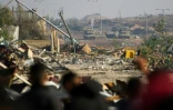Chars israéliens stationnés dans le couloir de Netzarim au passage des déplacés en route vers le nord de la bande de Gaza, le 27 janvier 2025