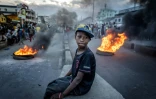 Image du photographe Luis Tato montrant un enfant assistant Ă des affrontements entre manifestants et forces de l'ordre lors du mouvement de la Gen Z malgache, Ă Antananarivo le 9 octobre 2025