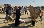 Des Palestiniens déplacés marchent le long d'une route pour recevoir des colis d'aide humanitaire d'un centre d'aide soutenu par les États-Unis à Rafah, dans le sud de la bande de Gaza, le 5 juin 2025