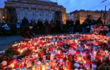 Des fleurs et des bougies déposées devant l'Université Charles de Prague, au lendemain d'une fusillade, le 22 décembre 2023 en République tchèque
