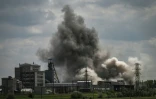 De la fumée s'élève dans le ciel à  Soledar dans l'est de l'Ukraine, le 24 mai 2022