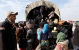 Des familles qui ont fui les combats montent dans des camions des forces irakiennes, le 8 mars 2017 à Badouch, au nord-ouest de Mossoul