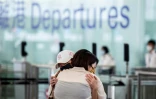 Des habitants disent adieu à leurs proches avant de prendre un vol pour Londres à l'aéroport de Hong Kong le 17 juillet 2021
