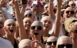 Des fans du rappeur américain Pitbull portent de faux crânes chauves avant un concert de l'artiste, le 10 juillet 2026 à Londres 