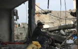Un Palestinien dans les ruines de sa maison après une frappe israélienne sur le camp de réfugiés d'al-Maghazi dans le centre de la bande de Gaza, le 25 décembre 2023