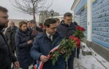 Le nouveau ministre des Affaires étrangères français, Stéphane Séjourné, (c) et son homologue ukrainien Dmytro Kouleba (d) déposent des fleurs devant "Le mur du souvenir des morts pour l'Ukraine", le 13 janvier 2024 à Kiev