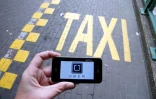 Le logo d'Uber affiché sur un smartphone pendant une manifestation de taxis à Bruxelles contre l'application, le 13 septembre 2015 