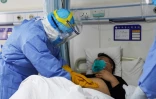 Un membre du personnel médical ausculte un patient porteur du nouveau coronavirus placé en isolement dans un hôpital de Zouping, dans la province chinoise de Shandong, le 28 janvier 2020 