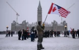 Un manifestant portant les drapeaux américain et canadien à Ottawa, au Canada, le 12 février 2022