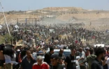 Des Palestiniens déplacés transportent des sacs d'aide, de retour d'un centre de distribution de la GHF dans le centre de la bande de Gaza, le 29 mai 2025