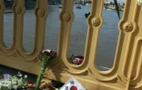 Photo prise le 1er juin 2019 à Budapest, montrant des fleurs, des bougies et un drapeau sud-coréen sur le pont Marguerite qui enjambe le Danube, au-dessus du lieu de la collision entre un bateau de croisière et une embarcation de touristes, qui a fait 7 morts et 21 disparus, principalement des Sud-Coréens.
