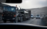 Un camion de l'armée arménienne transporte un véhicule blindé près de Stepanakert, le 12 novembre 2020