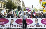 Des manifestants, descendus dans la rue à l'appel de la CGT, de la FSU et de Solidaires, pour réclamer des hausses de salaires et défendre l'emploi, tiennent une banderole, le 8 octobre à Paris