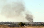 De la fumée s'élève de Syrte où les forces du gouvernement d'union nationale bombardent les positions de l'EI, le 18 juillet 2016