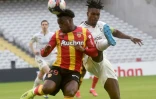 L'attaquant de Lens, Arnaud Kalimuendo-Muinga (g), à la lutte avec le défenseur de Metz, le Ghanéen John Boye, lors de leur match de L1, le 14 mars 2021 au stade Bollaert à Lens