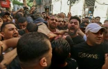 Une foule de Palestiniens évacue un Palestinien blessé dans un raid israélien à Naplouse en Cisjordanie occupée, le 9 août 2022 