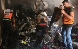 Des Palestiniens et des secouristes fouillent les décombres d'un appartement détruit dans un bombardement israélien du quartier d'al-Daraj dans la ville de Gaza, le 3 juillet 2024