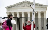 Un opposant au droit à l'avortement et une militante pro-choix face à face devant la Cour suprême des Etats-Unis, le 5 mai 2022 à Washington 
