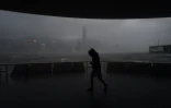 Un homme tente de marcher malgré le vent à Hong Kong, touché par un violent typhon, le 23 août 2017