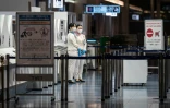 Des employés de l'aéroport de Tokyo contrôlent les arrivées alors que de nouvelles mesures sanitaires ont été annoncées, le 29 novembre 2021