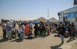 Des réfugiés afghans arrivent avec leurs biens après avoir traversé la frontière avec l'Iran, à Islam Qala, dans la province d'Herat, le 24 juillet 2025 en Afghanistan