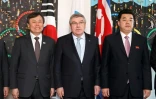 Le président du CIO Thomas Bach (c) pose avec le président du Comité olympique et ministre des sports nord-coréen Kim Il Guk (D) et le ministre des sports sud-coréen Do Jong-hwan au siège du CIO à Lausanne, le 15 février 2019