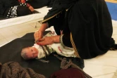 Une femme emmaillote un nouveau-né à la maternité de Khost en Afghanistan, le 7 août 2018