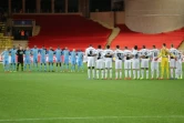Les joueurs de Monaco et Metz (L2) observent une minute de silence en mémoire d'Emiliano Sala avant leur match de Coupe de France, le 22 janvier 2019 à Monaco