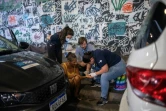 La médecin Yasmine Nascimento (d) procure des soins à une femme sans-abri dans les environs de Rio de Janeiro, le 31 juillet 2023 au Brésil