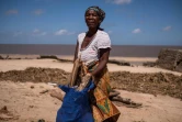 Une femme ramasse des objets sur la plage pour faire du feu et pouvoir cuisiner à Beira, au Mozambique, le 24 mars 2019