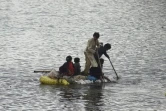 Des enfants utilisent un radeau pour se frayer un chemin dans une zone inondée après de fortes pluies de mousson dans la banlieue de Sukkur, dans la province du Sindh, au Pakistan, le 27 août 2022