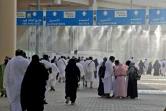 Des goutelettes d'eau sont pulvérisées pour permettre aux fidèles musulmans de se rafraîchir avant de jeter des cailloux lors d'un rituel de lapidation symbolique de Satan, près de la ville sainte de la Mecque en Arabie saoudite, le 20 juillet 2021