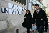 Gisèle Pelicot (gauche) marche au côté de son avocat Me Stéphane Babonneau près d'une inscription murale "Viol est un viol", le 14 novembre 2024 à Avignon