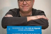 L'archiviste de Marseille Gilles Castagno avec son encyclopédie de quatre volumes sur le club le 4 décembre 2018 dans sa maison à Marseille