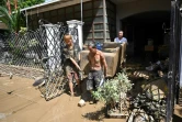 As floodwaters subsided, residents were left with the task of cleaning up the mud and destruction left behind