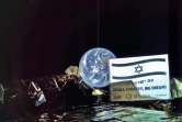 Photo diffusée le 5 mars 2019 par SpaceIL et Israel Aerospace Industries (IAI), prise dans l'espace par la première sonde lunaire israélienne, à une distance de 37.600 km de la Terre, visible en arrière-plan de l'engin spatial