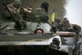 Des soldats ukrainiens à bord de transports de troupes blindés, non loin de la ligne du front, à Izyum, dans la région de Kharkiv, le 18 avril 2022