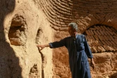 L'instituteur Mahmoud al-Mheilejinspecte les murs d'une maison en terre à coupole du village d'Oum Amouda Kabira, dans la province d'Alep, en Syrie, le 11 août 2023