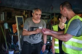 Un bénévole des Restos du Coeur offre un café à Stefan, un SDF qui vit sous un pont, photo du 30 juillet 2018